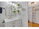 White bathroom vanity with a large mirror and shelves at 1328 Cottonwood St, Charleston, SC 29403