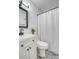Clean bathroom with white vanity, black fixtures, and patterned floor at 1328 Cottonwood St, Charleston, SC 29403