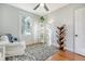 Cozy bedroom with hardwood floors, white armchair, and a built-in bookshelf at 1328 Cottonwood St, Charleston, SC 29403