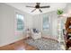 Serene bedroom with hardwood floors, white armchair and two windows at 1328 Cottonwood St, Charleston, SC 29403