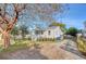 White cottage with a metal roof, front porch, and side yard at 1328 Cottonwood St, Charleston, SC 29403