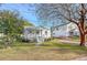 White cottage with a metal roof, front porch, and well-manicured lawn at 1328 Cottonwood St, Charleston, SC 29403