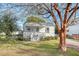 Charming white cottage with a metal roof, front porch, and landscaped yard at 1328 Cottonwood St, Charleston, SC 29403