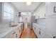 Bright eat-in kitchen with white shaker cabinets, marble countertops, and stainless steel appliances at 1328 Cottonwood St, Charleston, SC 29403