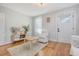Living room features hardwood floors, white chair and a view of the front door at 1328 Cottonwood St, Charleston, SC 29403