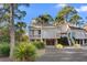 Elevated home with two-story design, screened porch, and attached garage at 1507 Marsh Haven, Seabrook Island, SC 29455