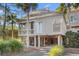 Elevated home with two-story design, screened porch, and attached garage at 1507 Marsh Haven, Seabrook Island, SC 29455