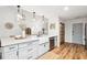 Open concept kitchen with island, farmhouse sink, and light gray cabinets at 172 Sea Cotton Cir, Charleston, SC 29412