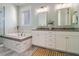 Elegant bathroom with double vanity, soaking tub, and glass shower at 1738 Trewin Ct, Charleston, SC 29492