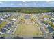 Aerial view of houses, a pond, playground, and community green space at 178 Garden Lily Ln, Summerville, SC 29485