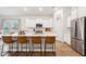 Modern kitchen island with seating, quartz countertops, and stainless steel appliances at 178 Garden Lily Ln, Summerville, SC 29485