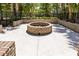 Round brick fire pit with seating area in a park-like setting at 1819 Heldsberg Dr, Charleston, SC 29414