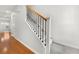 Modern staircase with a wood handrail and wrought-iron balusters at 1819 Heldsberg Dr, Charleston, SC 29414