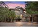 Two-story home with gray siding, gravel driveway, and lush landscaping at 2264 Seascape Ct, Seabrook Island, SC 29455