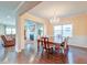 Open concept dining room with hardwood floors, chandelier, and view of living room at 2840 Conservancy Ln, Charleston, SC 29414