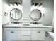 Modern bathroom boasts double sinks, granite countertops, and stylish light fixtures at 42 Summer Dr, Walterboro, SC 29488