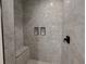 Spacious shower with gray marble-look tiles and built-in seat at 42 Summer Dr, Walterboro, SC 29488