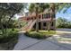 Two-story home with wrap-around porch, brick base, and palm trees at 4591 Cape Island Dr, Awendaw, SC 29429