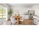 Kitchen nook with round wooden table, and white chairs near sliding door at 5540 Dalmore Dr, Ravenel, SC 29470