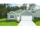 Gray exterior with white garage door, landscaping, and driveway at 5540 Dalmore Dr, Ravenel, SC 29470