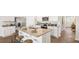 Open concept kitchen with island, stainless steel appliances, and hardwood floors at 5540 Dalmore Dr, Ravenel, SC 29470