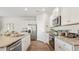 Modern kitchen with granite countertops, stainless steel appliances, and white cabinets at 5540 Dalmore Dr, Ravenel, SC 29470