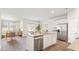 Open concept kitchen with island, stainless steel appliances, and hardwood floors at 5540 Dalmore Dr, Ravenel, SC 29470