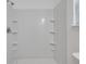 White tiled shower with built-in shelves at 607 Mountain Pine Road, Moncks Corner, SC 29461