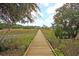 Long wooden boardwalk leading to the community dock at 109 Peninsula Dr, Hollywood, SC 29470
