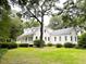 White farmhouse with large yard and mature trees at 115 Briarwood Ln, Summerville, SC 29483