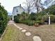 Landscaped backyard with stone path, lush greenery, and seating area at 12 John St # Includes 8 & 10, Charleston, SC 29403