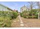 Stone path meanders through a lush, landscaped backyard at 12 John St # Includes 8 & 10, Charleston, SC 29403