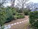 Landscaped backyard with stone path and lush greenery at 12 John St # Includes 8 & 10, Charleston, SC 29403