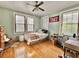 Light green bedroom with hardwood floors and multiple windows at 12 John St # Includes 8 & 10, Charleston, SC 29403