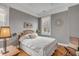 Bedroom with hardwood floors, window with shutters and a wooden bed frame at 12 John St # Includes 8 & 10, Charleston, SC 29403