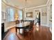 Bright dining room with hardwood floors, oval table, and chandelier at 12 John St # Includes 8 & 10, Charleston, SC 29403