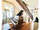 Grand entryway with hardwood floors, staircase, and a beautiful piano at 12 John St # Includes 8 & 10, Charleston, SC 29403