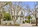 Charming yellow house with white picket fence and landscaped yard at 12 John St # Includes 8 & 10, Charleston, SC 29403