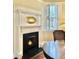White fireplace with black tile hearth and a warm fire at 12 John St # Includes 8 & 10, Charleston, SC 29403