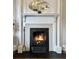 Elegant fireplace with ornate mantel and glowing fire at 12 John St # Includes 8 & 10, Charleston, SC 29403