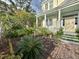 Landscaped front yard with brick walkway leading to porch at 12 John St # Includes 8 & 10, Charleston, SC 29403