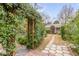 Stone path leads to charming cottage through arbor at 12 John St # Includes 8 & 10, Charleston, SC 29403