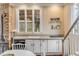 Charming kitchen features white cabinets, stainless steel appliances, and exposed brick at 12 John St # Includes 8 & 10, Charleston, SC 29403