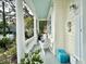 Relaxing front porch with white rocking chairs and potted plants at 12 John St # Includes 8 & 10, Charleston, SC 29403