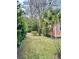 Landscaped side yard with lush greenery and palm trees at 12 John St # Includes 8 & 10, Charleston, SC 29403