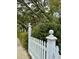 White picket fence with ball finials and lush green shrubs at 12 John St # Includes 8 & 10, Charleston, SC 29403