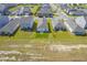 Aerial view of houses and a large open field at 120 Clear Tide Dr, Summerville, SC 29486