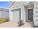 Modern garage and front entry with black door and white siding at 120 Clear Tide Dr, Summerville, SC 29486
