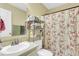 Bathroom with floral shower curtain and a shelving unit at 141 Penzance Blvd, Goose Creek, SC 29445