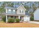 Two-story house with a gray roof, beige siding, and a white garage door at 141 Penzance Blvd, Goose Creek, SC 29445